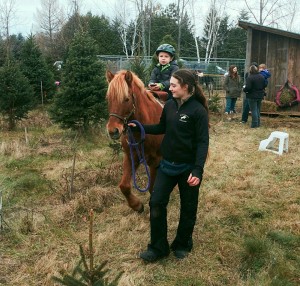Tree expert and pony whisperer, Julie Barrett, takes some down time at the petting zoo. Don’t let her gentle demeanor fool you — she also wields a mean hacksaw.